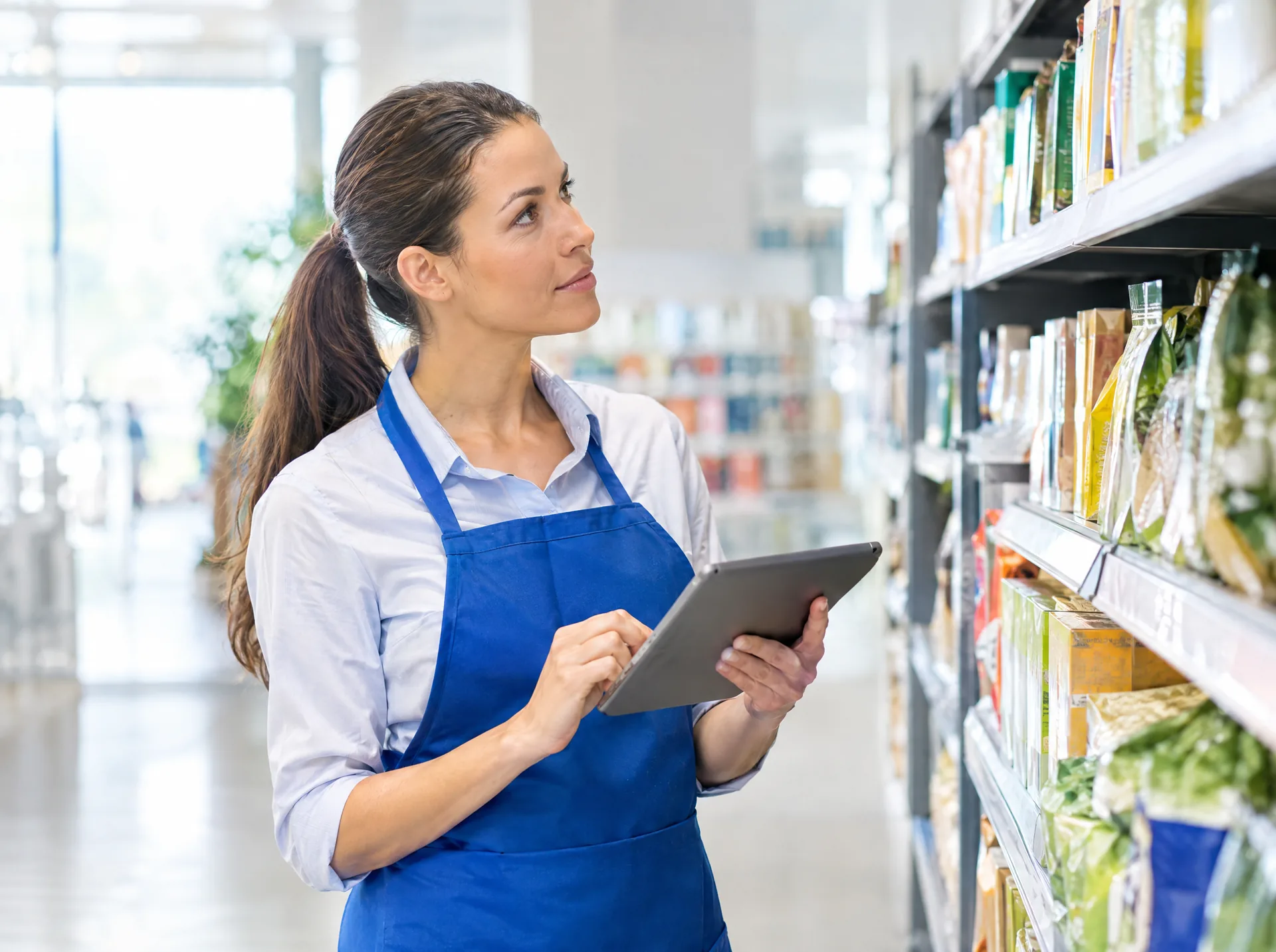 Store associate with a tablet in a retail aisle