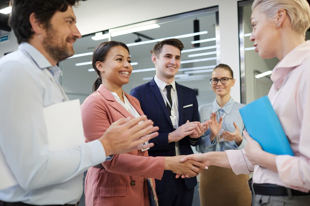 Colleagues shaking hands in an office