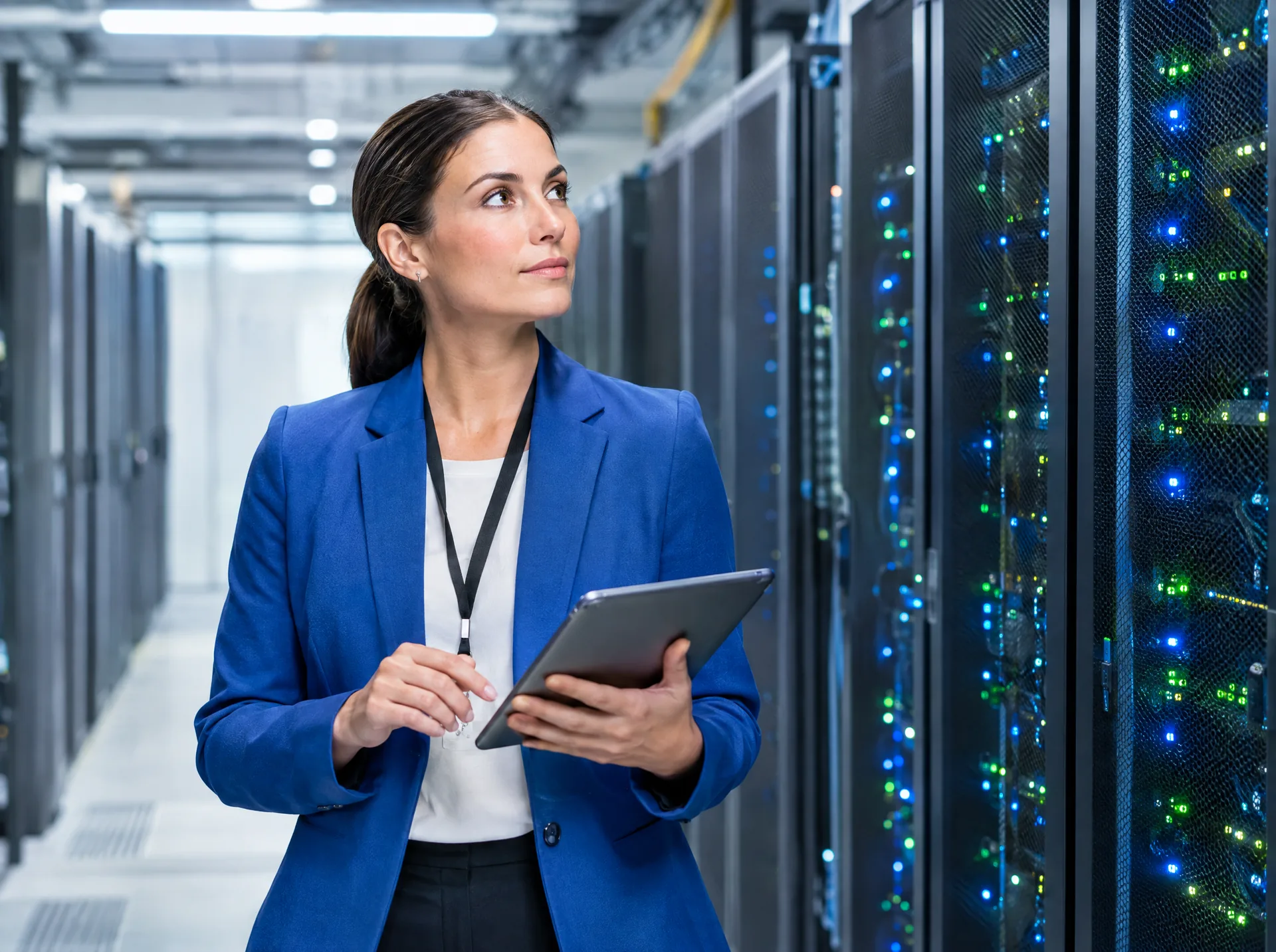 Engineer with a tablet in a data centre aisle