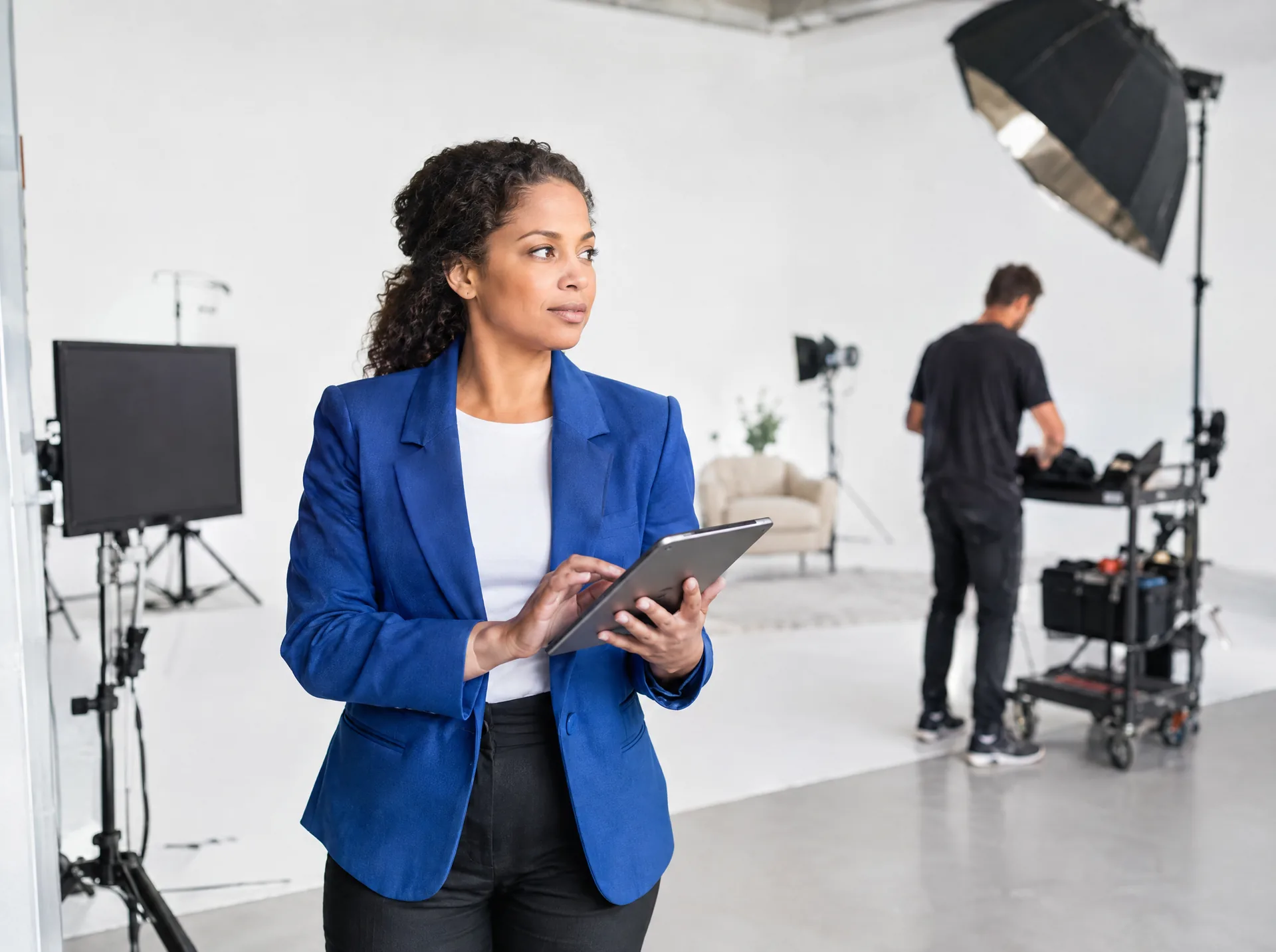 Producer with a tablet on a television studio set